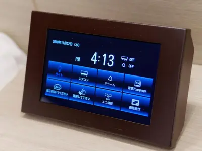 a digital alarm clock sitting on top of a table at Hotel Keihan Tsukiji Ginza Grande in Tokyo