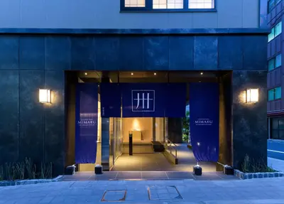 an entrance to a building with a blue facade at MIMARU Tokyo Nihombashi Suitengumae in Tokyo