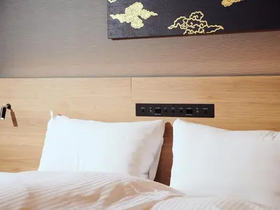a bed with two white pillows and a wooden headboard at MIMARU Tokyo Nihombashi Suitengumae in Tokyo