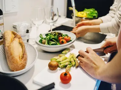 a group of people sitting at a table with food at MIMARU Tokyo Nihombashi Suitengumae in Tokyo