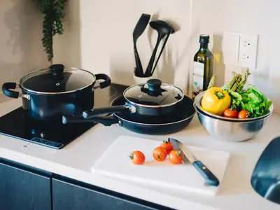 a kitchen counter with a pot and vegetables on a cutting board at MIMARU Tokyo Nihombashi Suitengumae in Tokyo