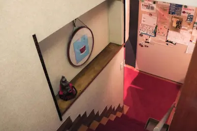 a dog sitting on the floor in front of a mirror at Ito Ryokan in Tokyo
