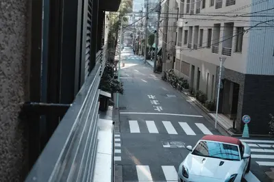 a white car parked on the side of a street at Ito Ryokan in Tokyo