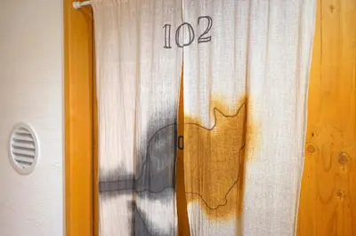 a door with a number on the side of a curtain at \u30b2\u30b9\u30c8\u30cf\u30a6\u30b9\u9ad8\u5186\u5bfa\u7d14\u60c5\u30db\u30c6\u30eb -Guest House Koenji Junjo Hotel- in Tokyo