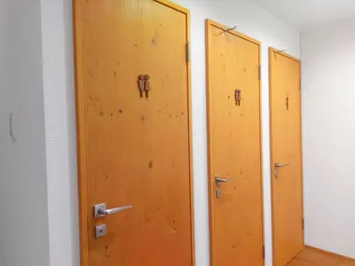 a row of wooden doors in a room at \u30b2\u30b9\u30c8\u30cf\u30a6\u30b9\u9ad8\u5186\u5bfa\u7d14\u60c5\u30db\u30c6\u30eb -Guest House Koenji Junjo Hotel- in Tokyo