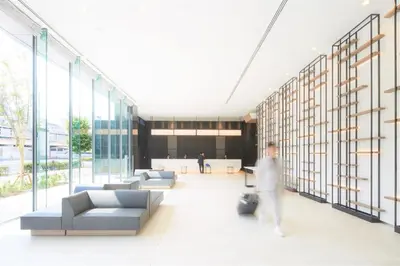 a person walking through a lobby of a building at Tmark City Hotel Tokyo Omori in Tokyo
