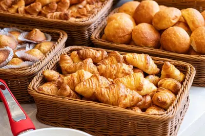 a bunch of baskets filled with croissants and other pastries at Tmark City Hotel Tokyo Omori in Tokyo