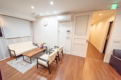 a living room with a couch and a table and chairs at Port House Shibuya in Tokyo
