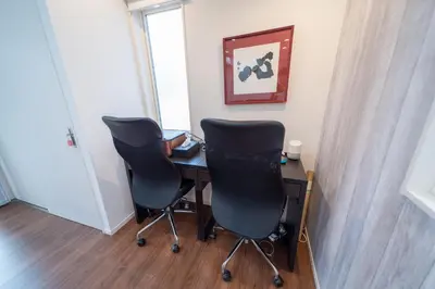 two chairs and a desk in a room with a window at Port House Shibuya in Tokyo