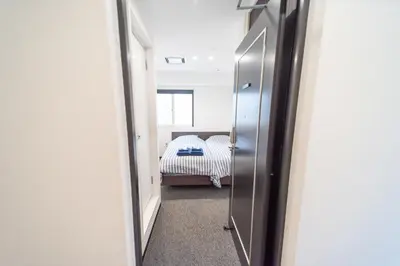 a hallway with a door leading to a bedroom at Port House Shibuya in Tokyo
