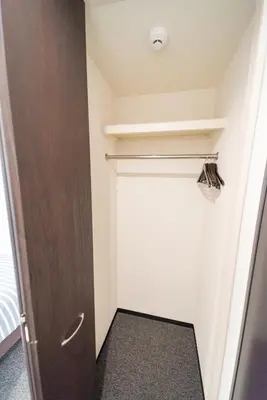 a hallway with a door in a room at Port House Shibuya in Tokyo