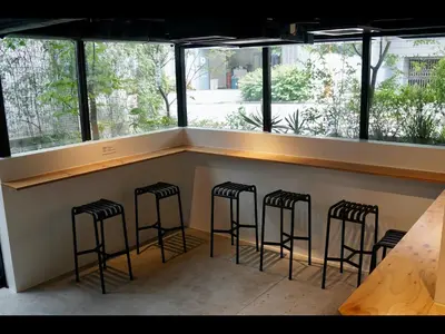 a row of stools at a bar in a restaurant at 9h nine hours Akasaka in Tokyo