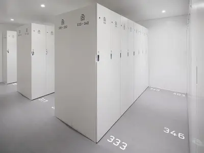 a row of white lockers in a room at 9h nine hours Akasaka in Tokyo