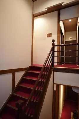 a staircase in a building with red stairs at Ryokan Sansuiso in Tokyo