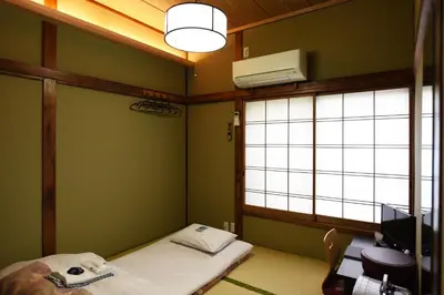 a hospital room with a bed and a window at Ryokan Sansuiso in Tokyo