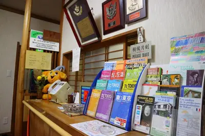 a display of books on a counter in a store at Ryokan Sansuiso in Tokyo