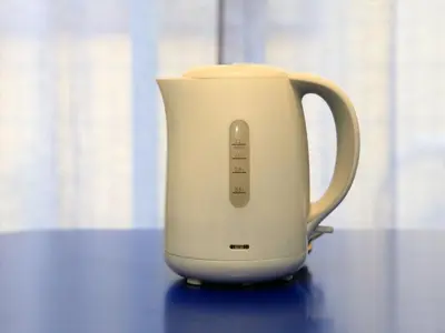 a white electric kettle sitting on a table at COTO Tokyo Asakusa 4 in Tokyo