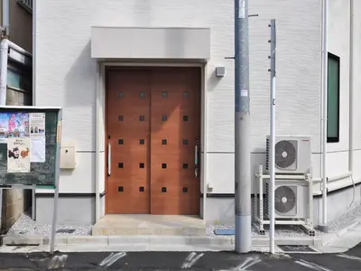 a brown door on the side of a building at COTO Tokyo Asakusa 4 in Tokyo