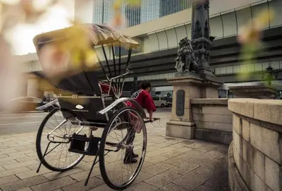 a bike parked on a sidewalk next to a statue at Mandarin Oriental, Tokyo in Tokyo