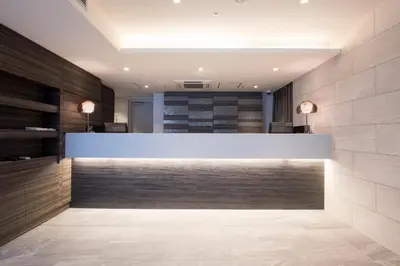 a lobby with a reception desk in a building at HOTEL MYSTAYS Gotanda in Tokyo