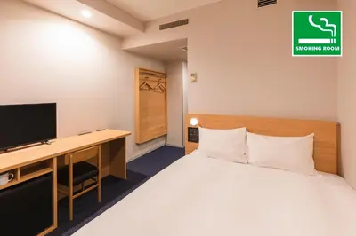 a bedroom with a bed and a desk and a tv at Sotetsu Fresa Inn Tokyo-Akasaka in Tokyo