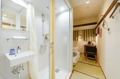 a bathroom with a shower and a sink and a toilet at The OneFive Tokyo Shibuya in Tokyo
