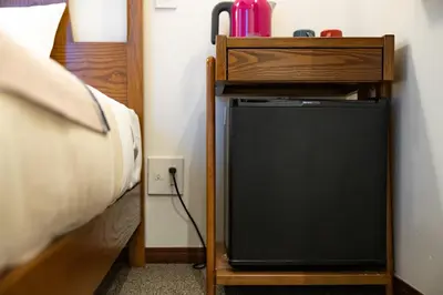a room with a bed and a desk with a television at The OneFive Tokyo Shibuya in Tokyo