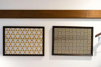 two framed prints of geometric patterns on a wall at The OneFive Tokyo Shibuya in Tokyo