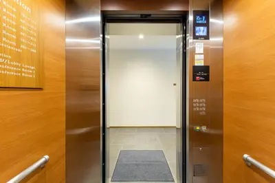 an elevator in a building with its door open at The OneFive Tokyo Shibuya in Tokyo