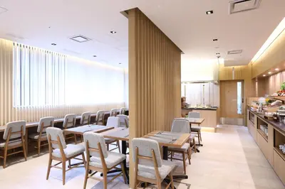a restaurant with tables and chairs and a counter at Hotel Gracery Asakusa in Tokyo
