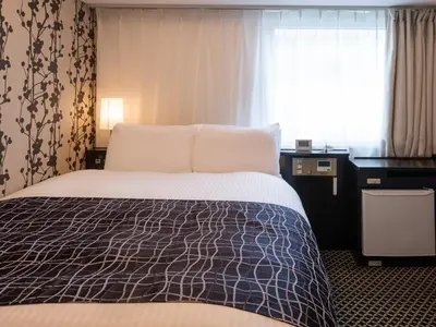 a hotel room with a bed and a window at APA Hotel Hatchobori Shintomicho in Tokyo