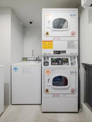 two washing machines and a refrigerator in a room at The Aoca Tokyo Sanno in Tokyo