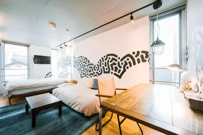 a room with two beds and a table at The Aoca Tokyo Sanno in Tokyo