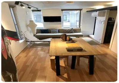 a living room with a table and a couch at The Aoca Tokyo Sanno in Tokyo