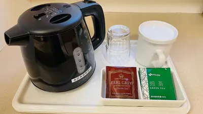 a coffee maker on a tray next to a cup at Hotel Route-Inn Shinagawa-Oimachi in Tokyo