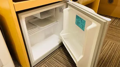 an empty refrigerator with its door open in a kitchen at Hotel Route-Inn Shinagawa-Oimachi in Tokyo