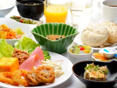 a table with plates of food and bowls of food at Hotel Route-Inn Tokyo Asagaya in Tokyo