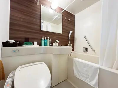 a bathroom with a white toilet and a sink at Hotel Route-Inn Tokyo Asagaya in Tokyo