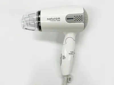 a white hairdryer on a white wall at Hotel Route-Inn Tokyo Asagaya in Tokyo