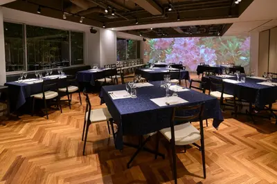 a room with tables and chairs with blue tablecloths at Hotel Asia Center of Japan in Tokyo