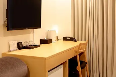 a hotel room with a desk with a television on it at Hotel Asia Center of Japan in Tokyo