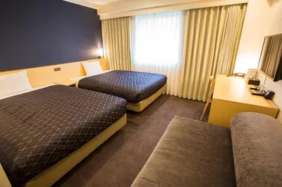 a hotel room with two beds and a window at Hotel Asia Center of Japan in Tokyo