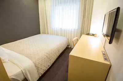 a hotel room with a bed and a television at Hotel Asia Center of Japan in Tokyo