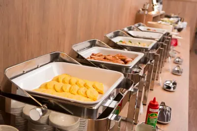 a row of trays of food on a buffet line at Hotel Route-Inn Grand Tokyo Toyocho in Tokyo
