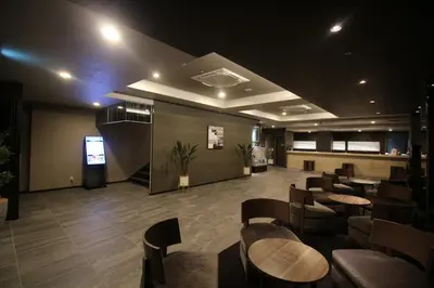 a restaurant with tables and chairs in a room at Hotel Route-Inn Grand Tokyo Toyocho in Tokyo