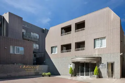 a large brick building with windows on it at Oakwood Residence Aoyama Tokyo in Tokyo