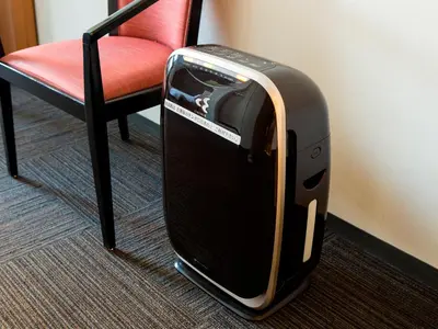a suitcase sitting on the floor next to a chair at Hotel Route-Inn Tokyo Ikebukuro in Tokyo