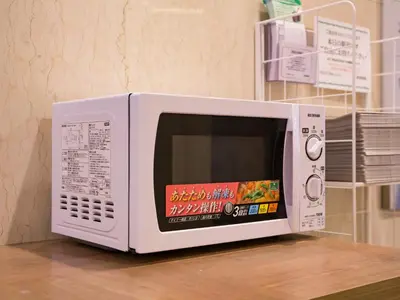 a microwave oven sitting on top of a table at Hotel Route-Inn Tokyo Ikebukuro in Tokyo