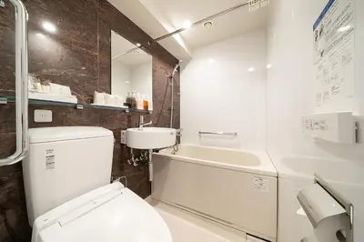 a bathroom with a toilet and a sink at Hotel Sunlite Shinjuku in Tokyo