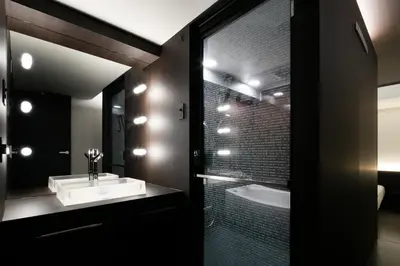 a bathroom with a sink and a shower with a tub at Hills Hotel Gotanda in Tokyo